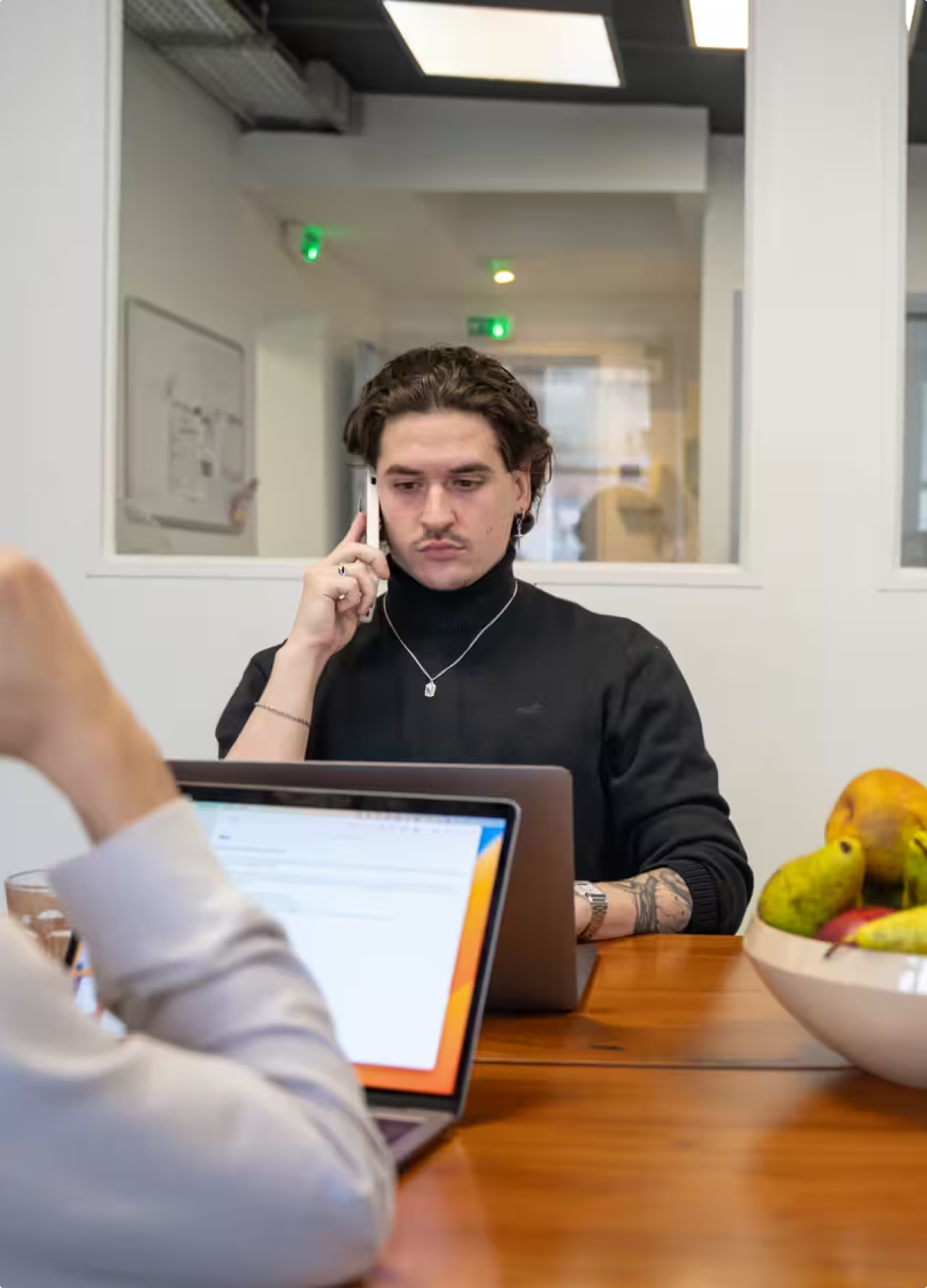 Salesperson on a call at a laptop in the Zeliq office
