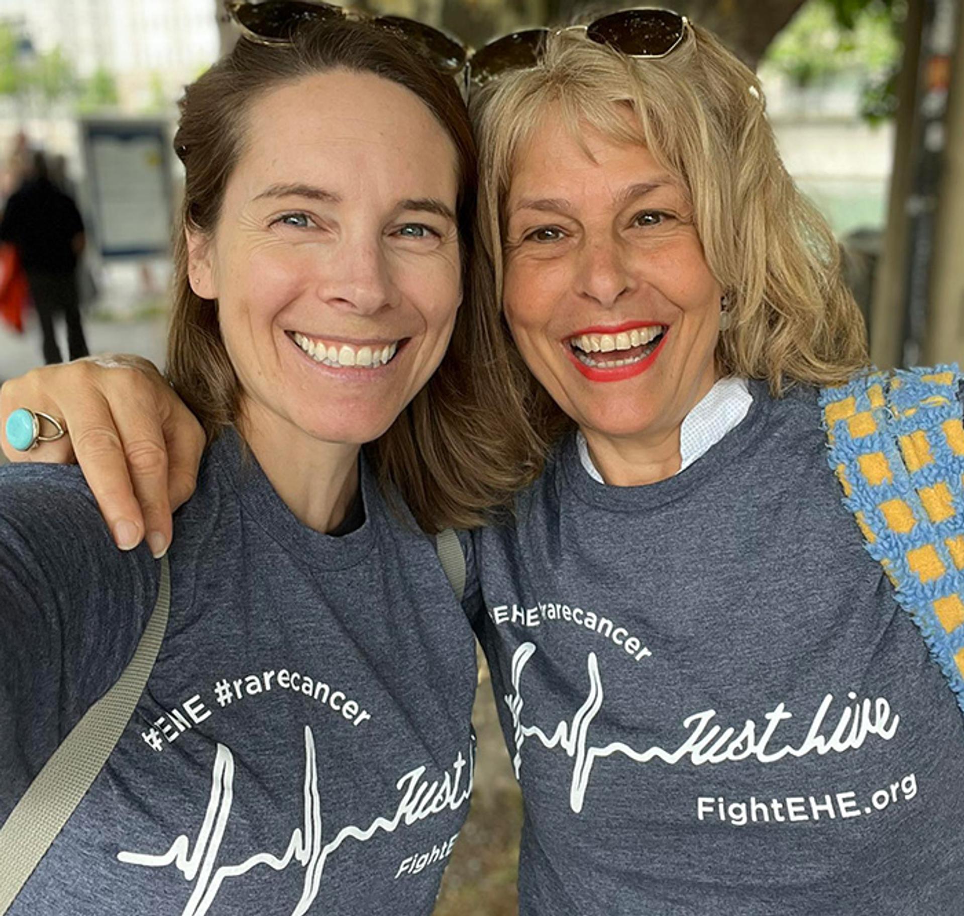 two women embracing and smiling