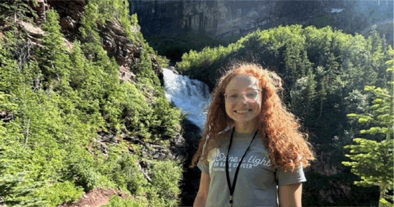 Sarah McMullan of the Lamar Lab in front of a waterfall