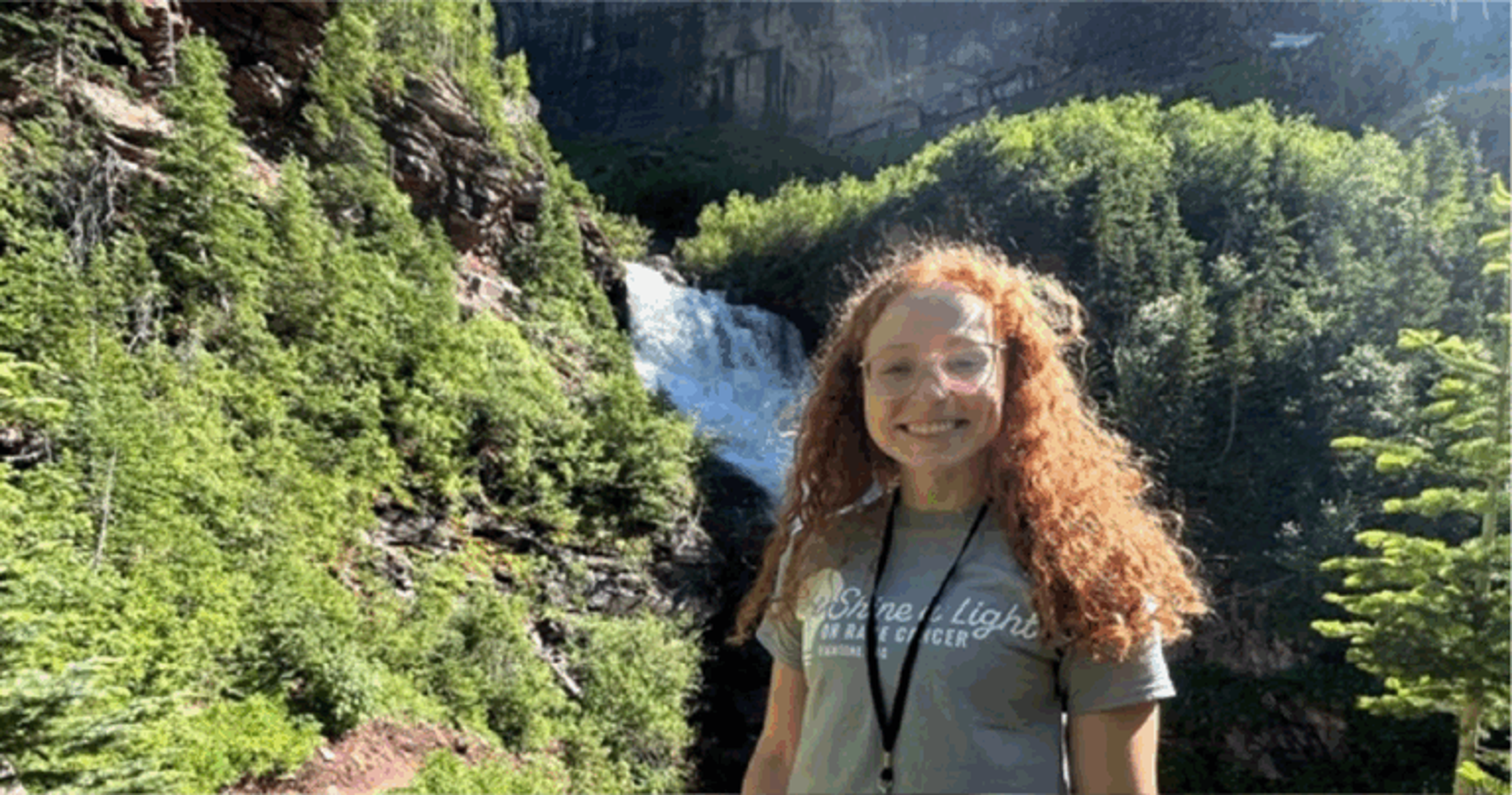 Sarah McMullan of the Lamar Lab in front of a waterfall