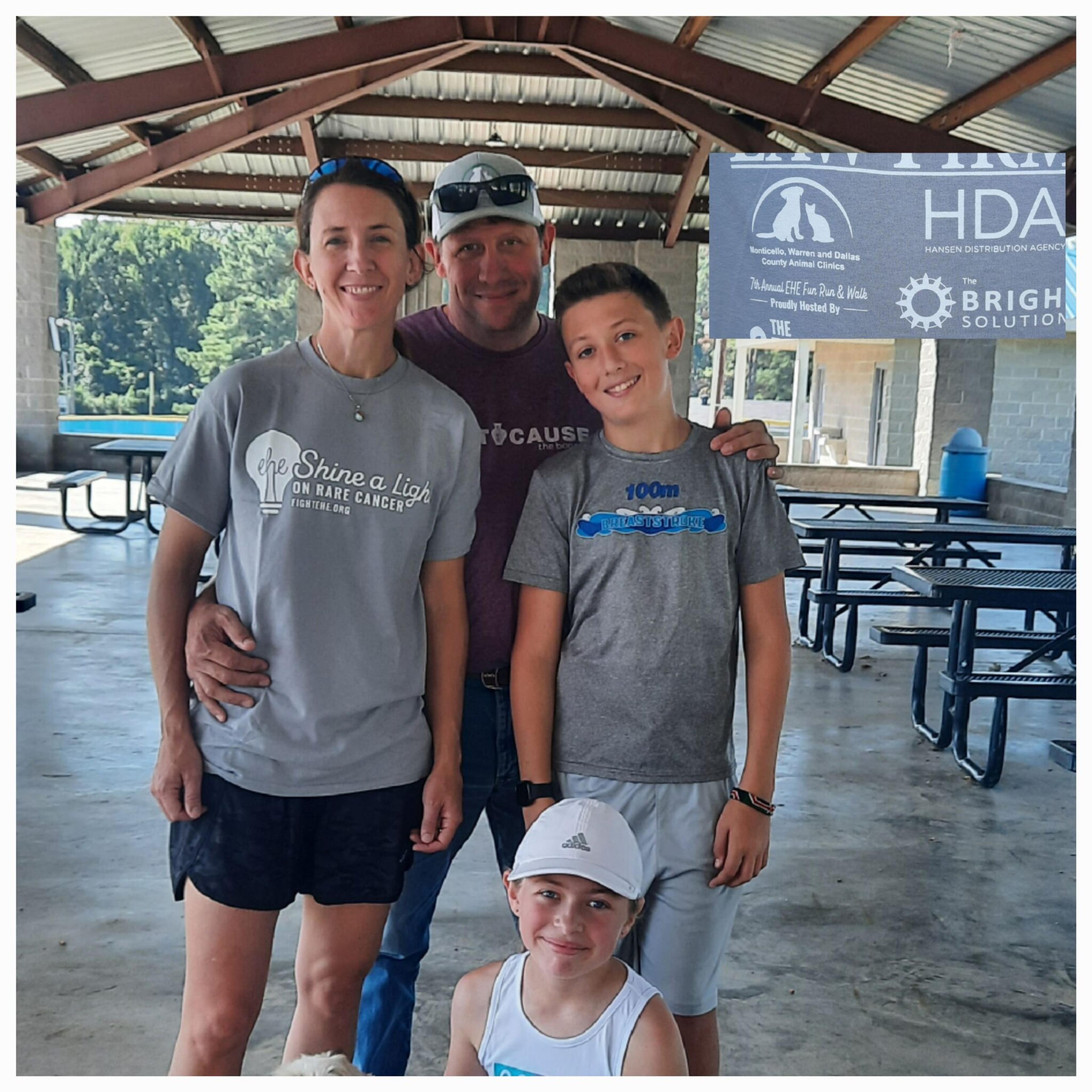 A family of four under a pavilion