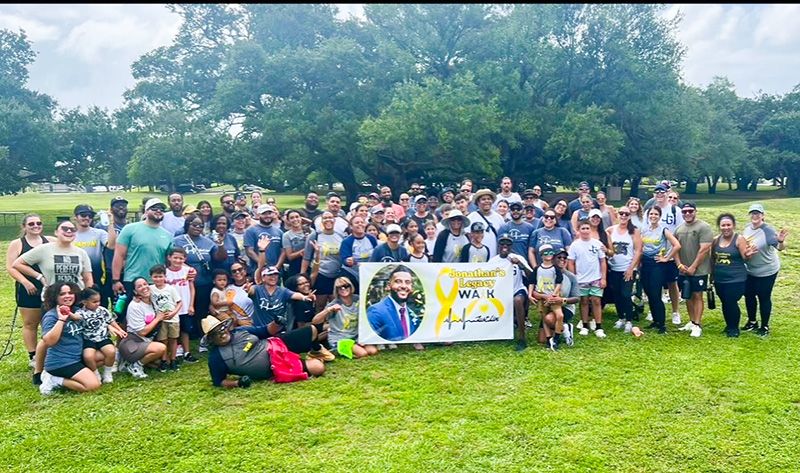 A large walk & run team gathers for a photo