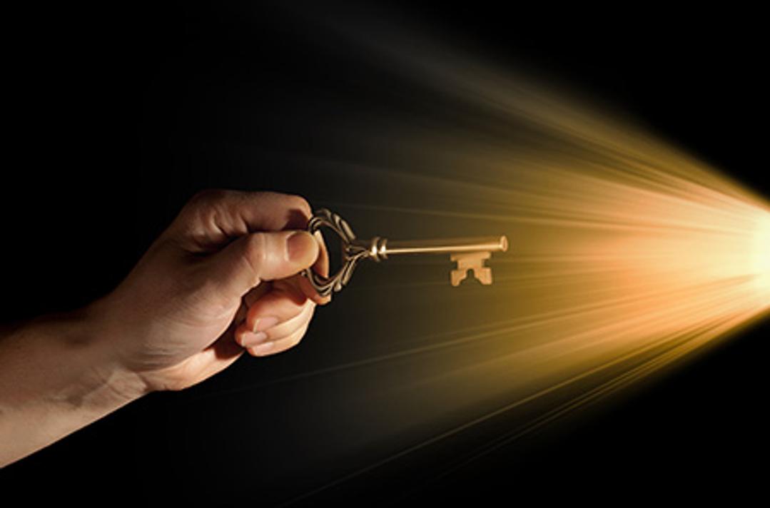 key moving into a lock filled with light