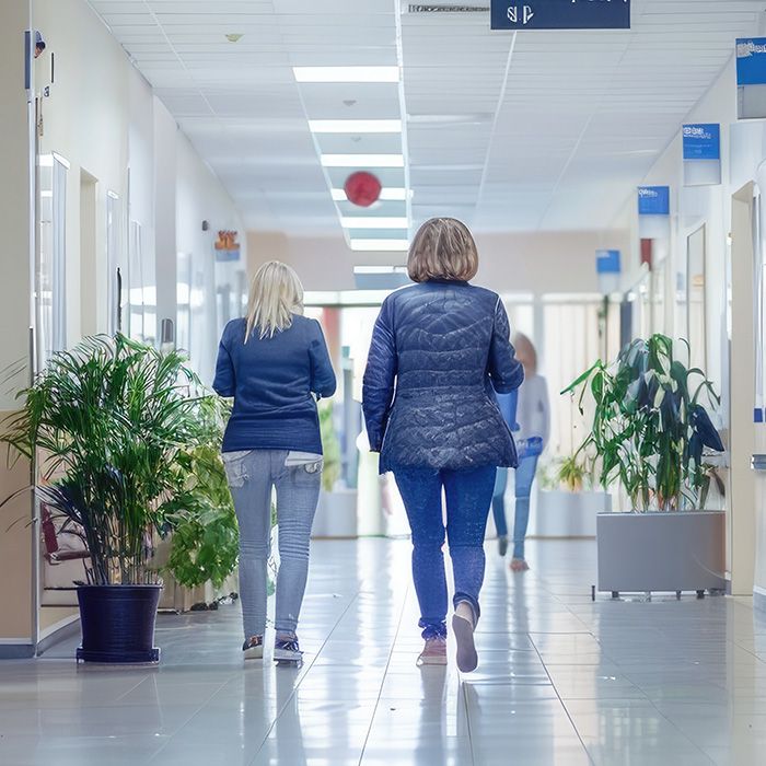 two women walking in a hospital