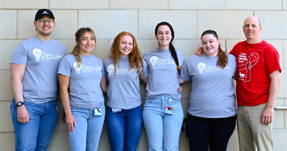 A groupf of folks in matching "Shine a light on rare cancer" tshirts