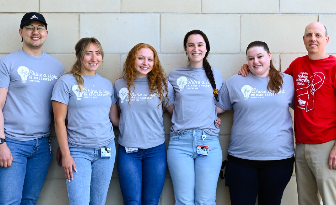 A groupf of folks in matching "Shine a light on rare cancer" tshirts