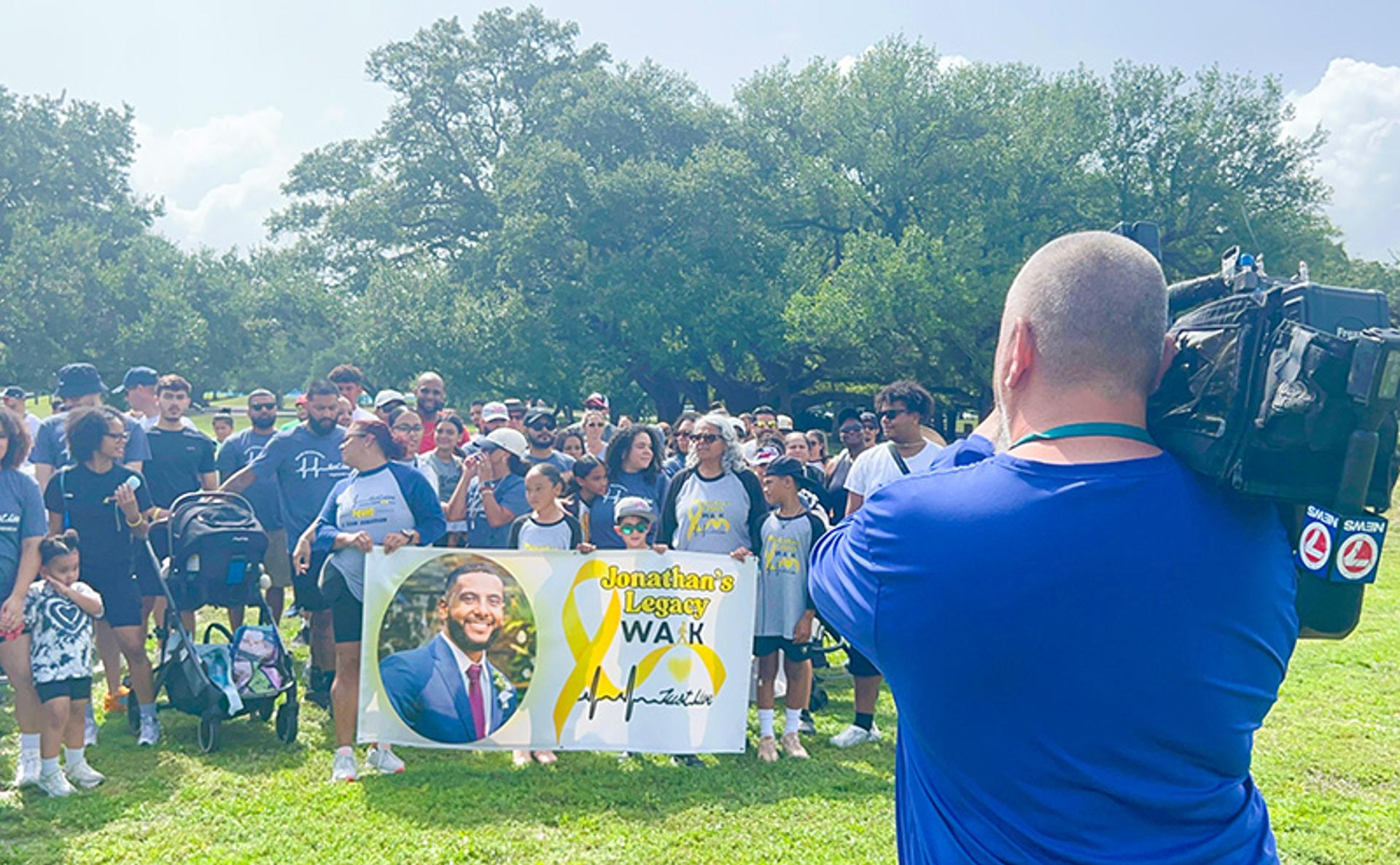 A camera man films a large walk & run team