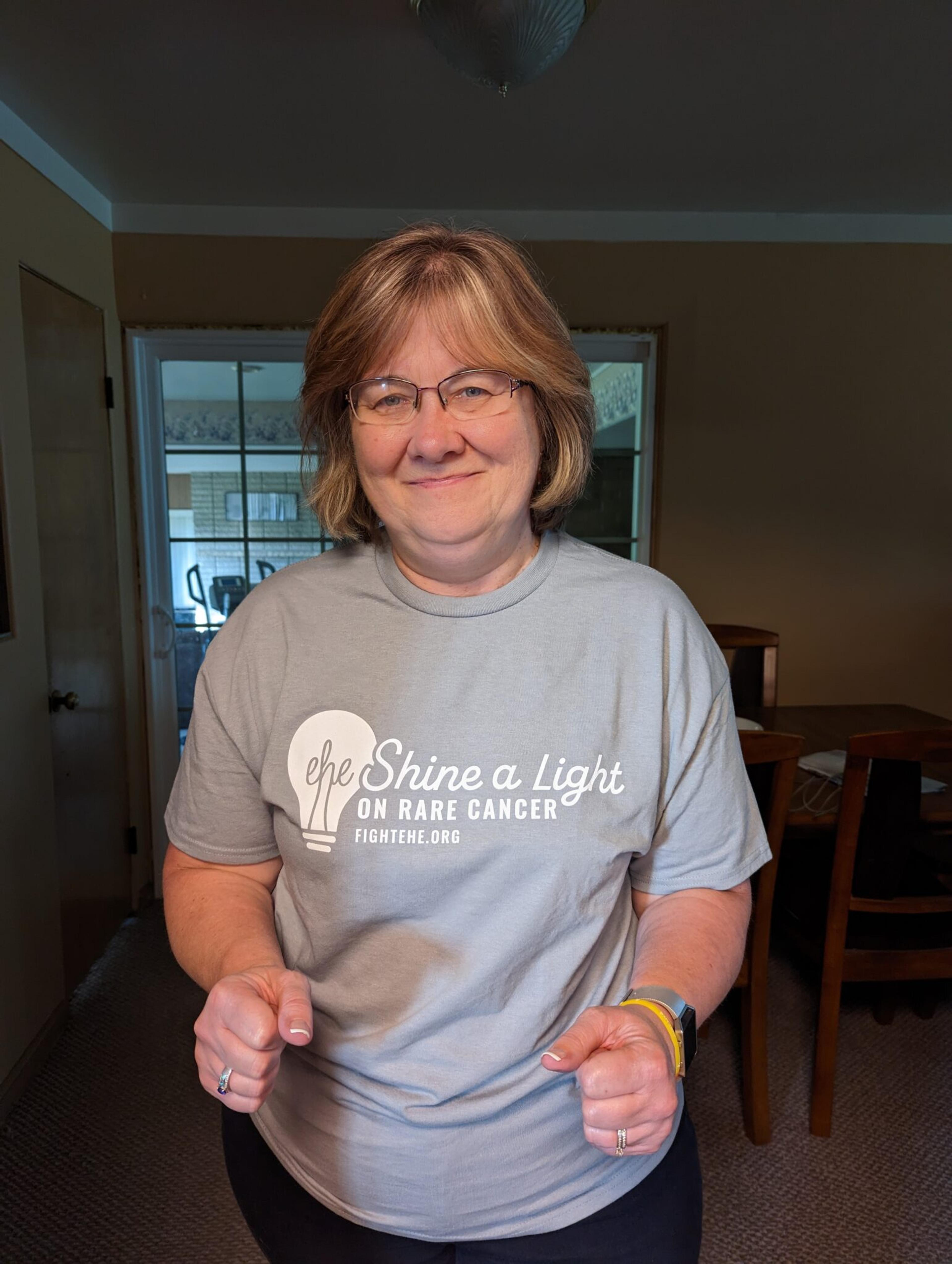 A woman smiles in here Shine a light tshirt