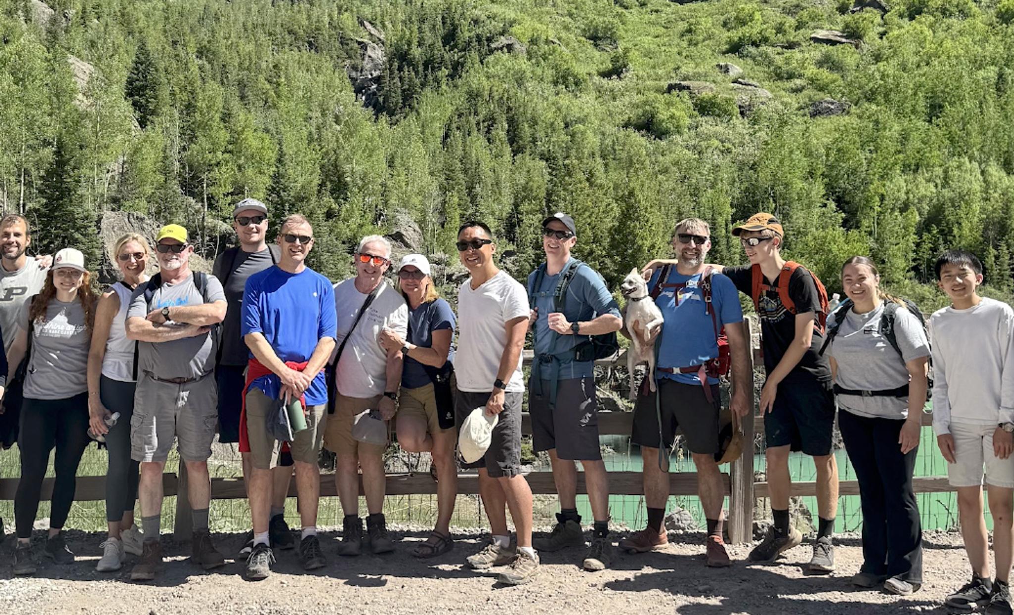 scientists standing in front of the San Juan mountains