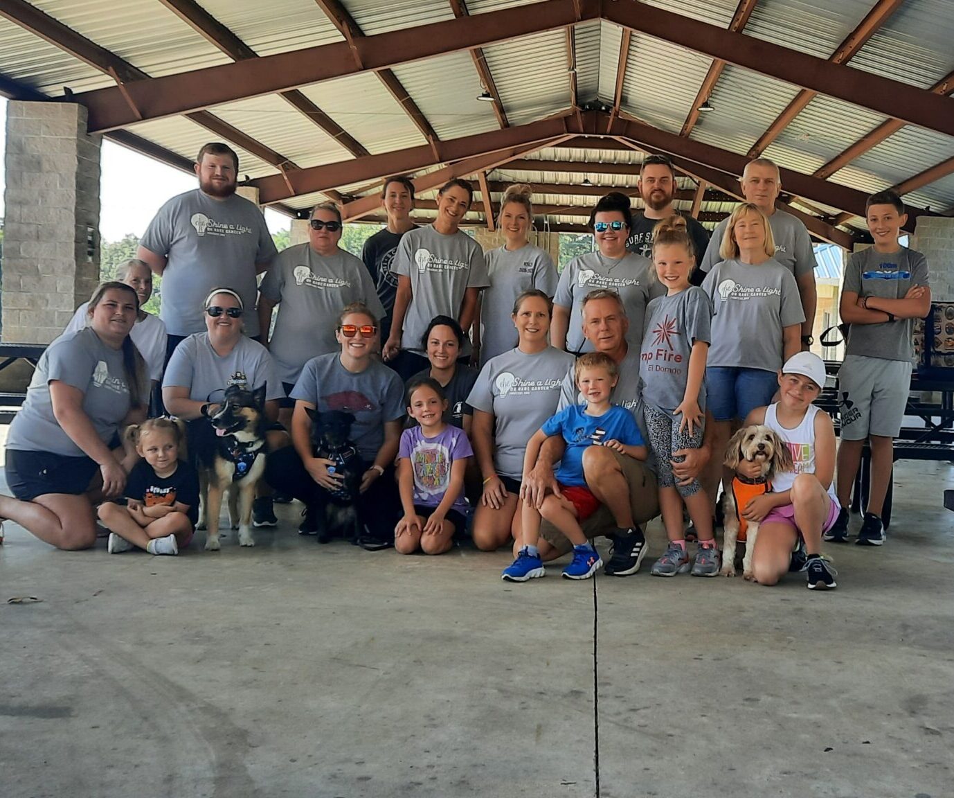 A large group of people get together for a photo under the pavilion