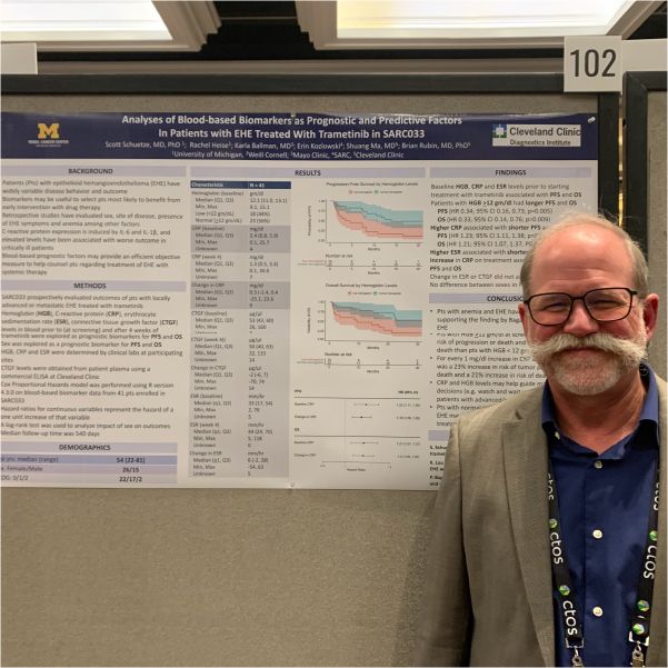 Dr. Scott Schuetze, University of Michigan, standing next to a print out of his work.