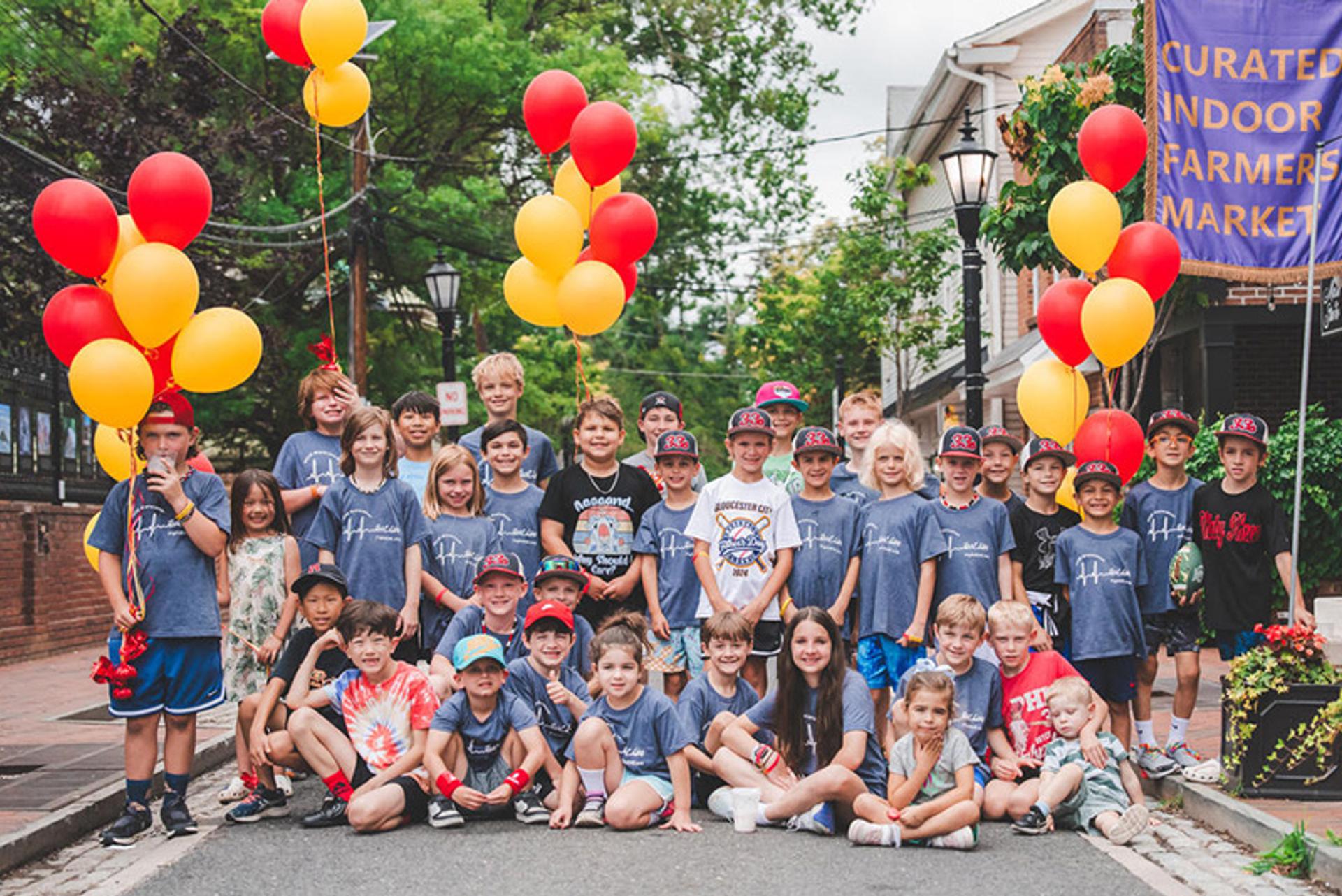 A group of children take a photo in their walk & run gear