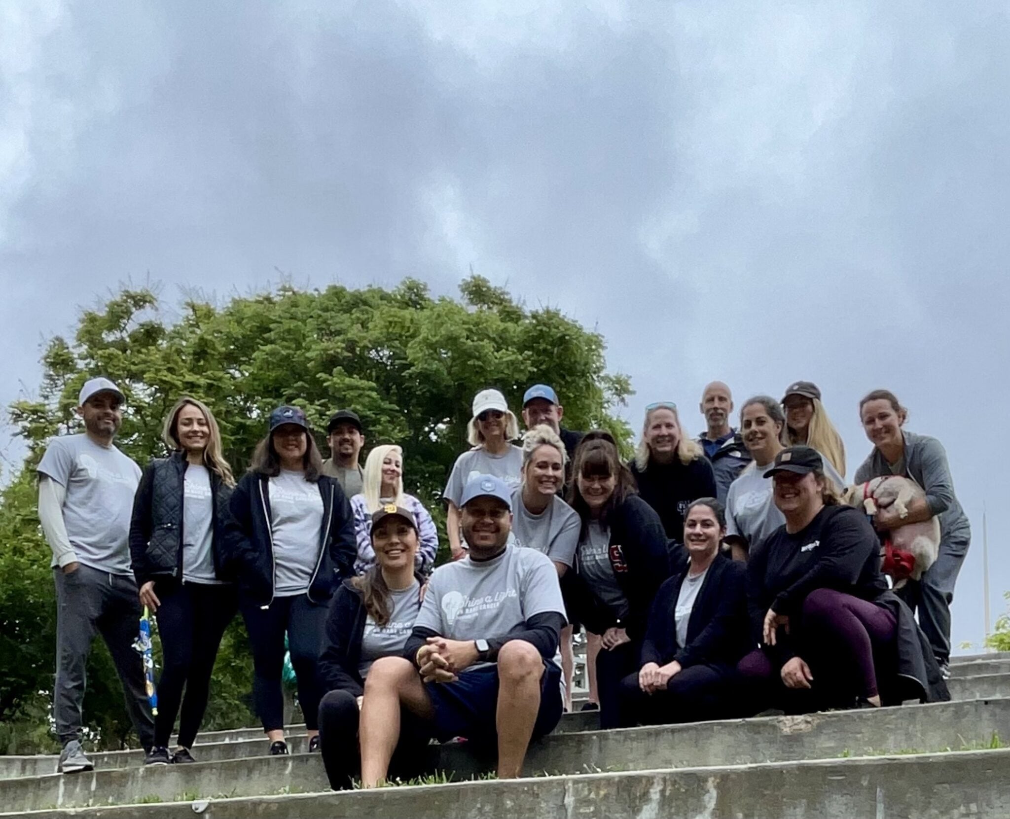 A group of people gather for a photo on a set of stairs