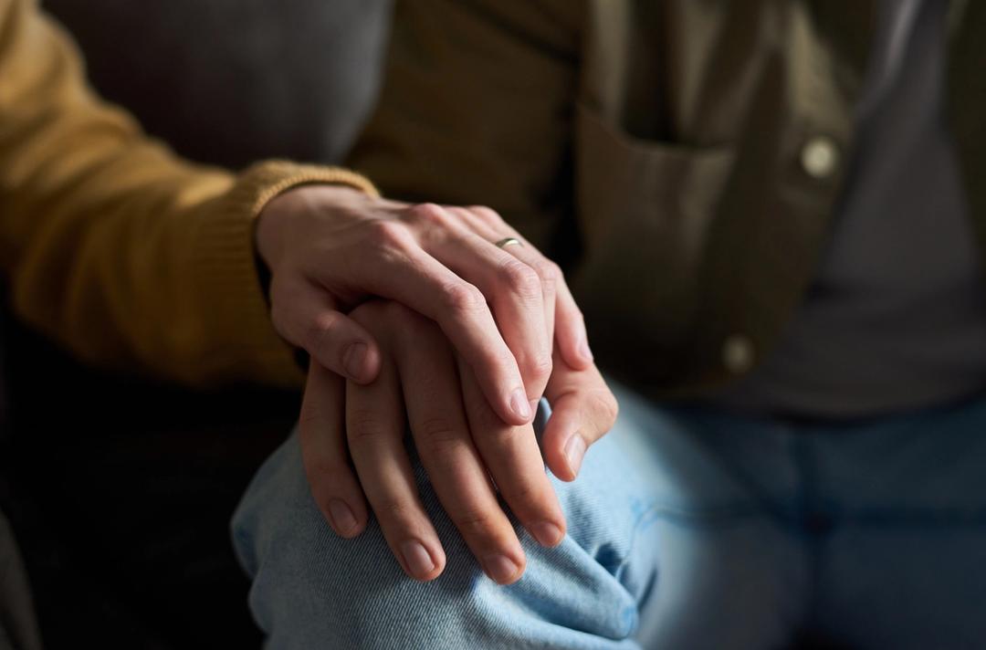 people holding hands on a knee