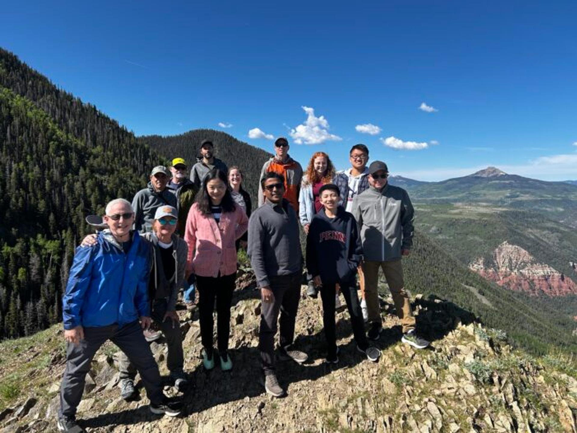 The crew standing in front of the mountain range.