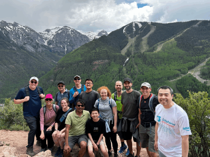 A group of people in front of a mountain
