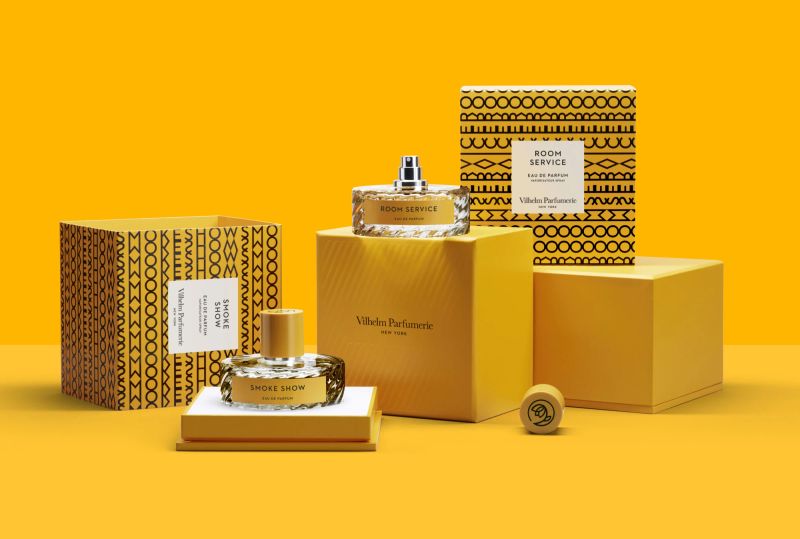 a bottle of perfume is sitting on top of a yellow box .