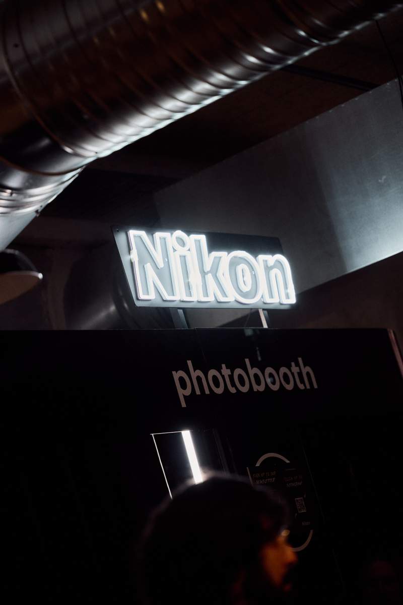 a nikon photo booth is lit up in the dark