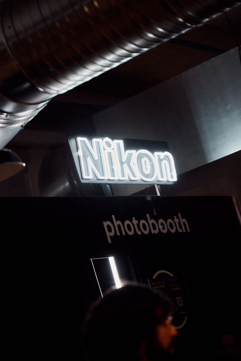 a nikon photo booth is lit up in the dark