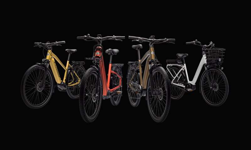 a group of bicycles are lined up in a row on a black background .