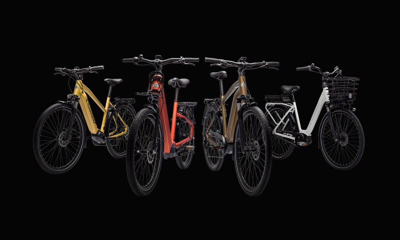 a group of bicycles are lined up in a row on a black background .