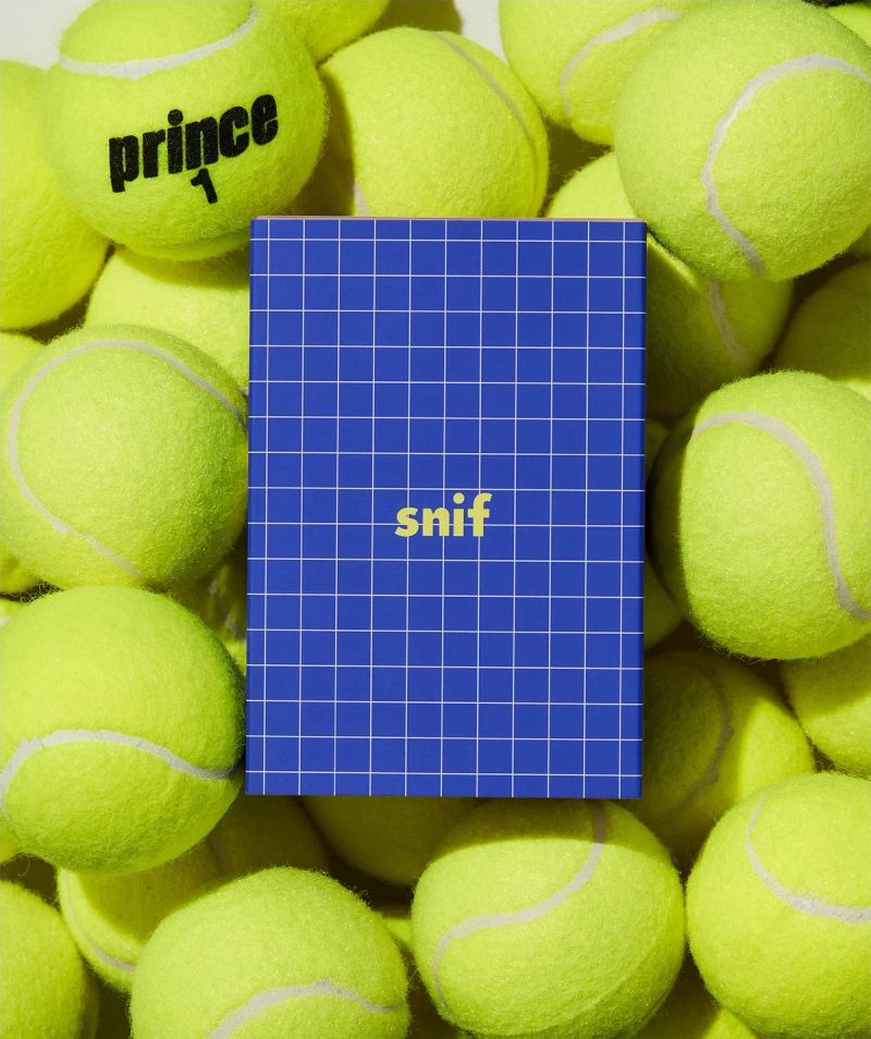 a pile of tennis balls with a blue cover that says snif