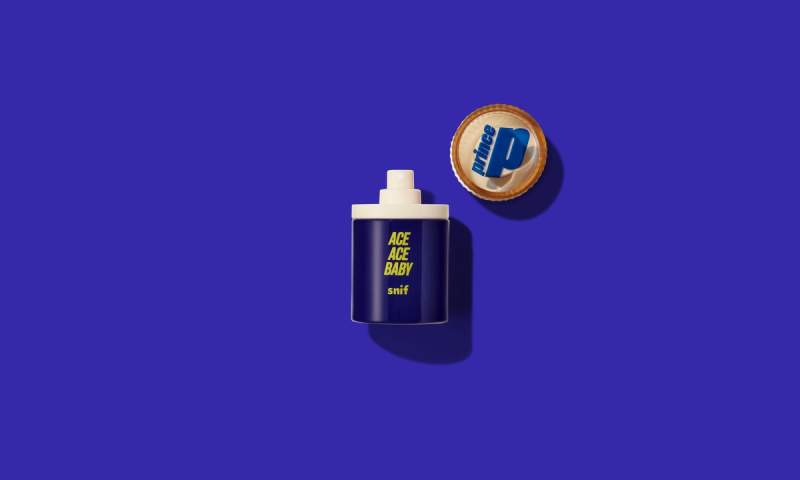 a bottle of perfume is sitting on a blue surface.