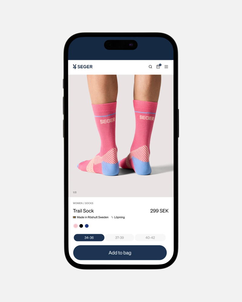 A smartphone displaying an e-commerce product page for pink Seger Trail Socks.
