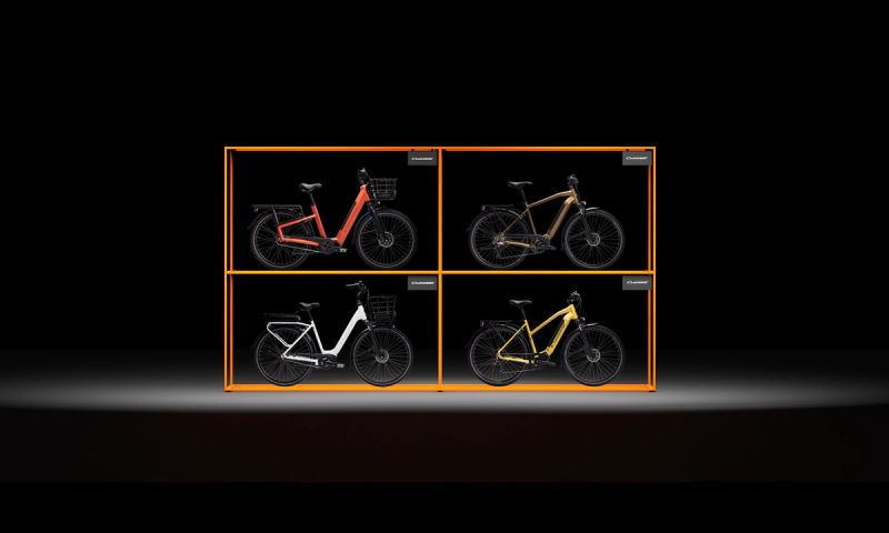 four bicycles are displayed in a box on a black background .