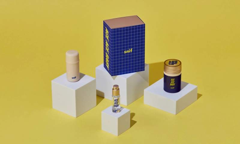 a group of boxes and bottles sitting on top of white cubes on a yellow background .