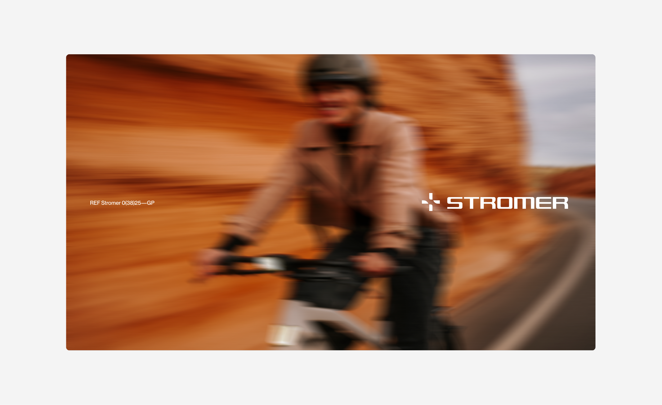 A blurred image of a person riding a bike with the word stromer on the bottom