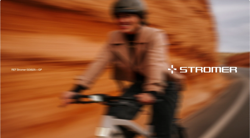 A blurred image of a person riding a bike with the word stromer on the bottom
