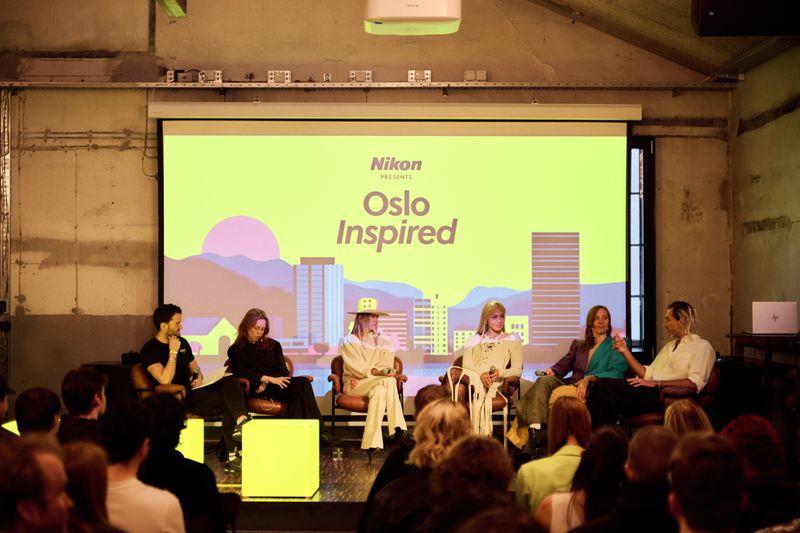 a group of people are sitting in front of a large screen .