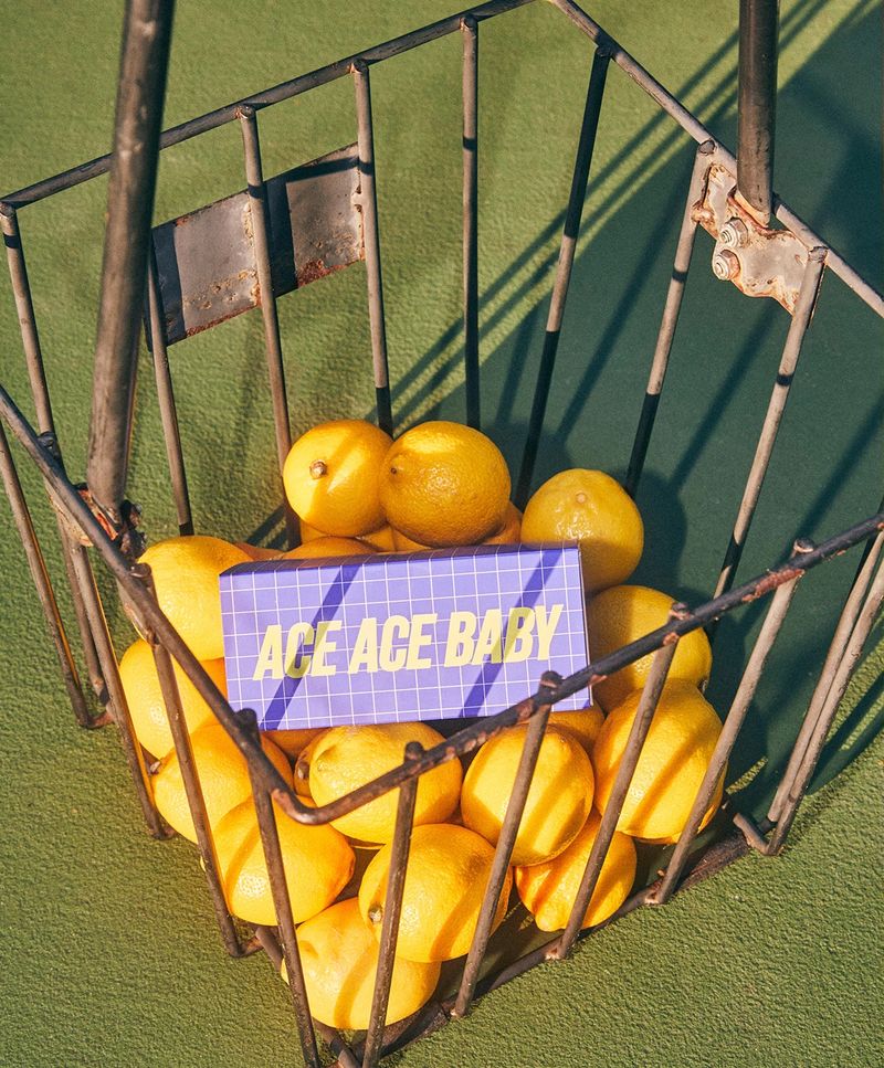a basket of lemons with a sign that says ace ace baby