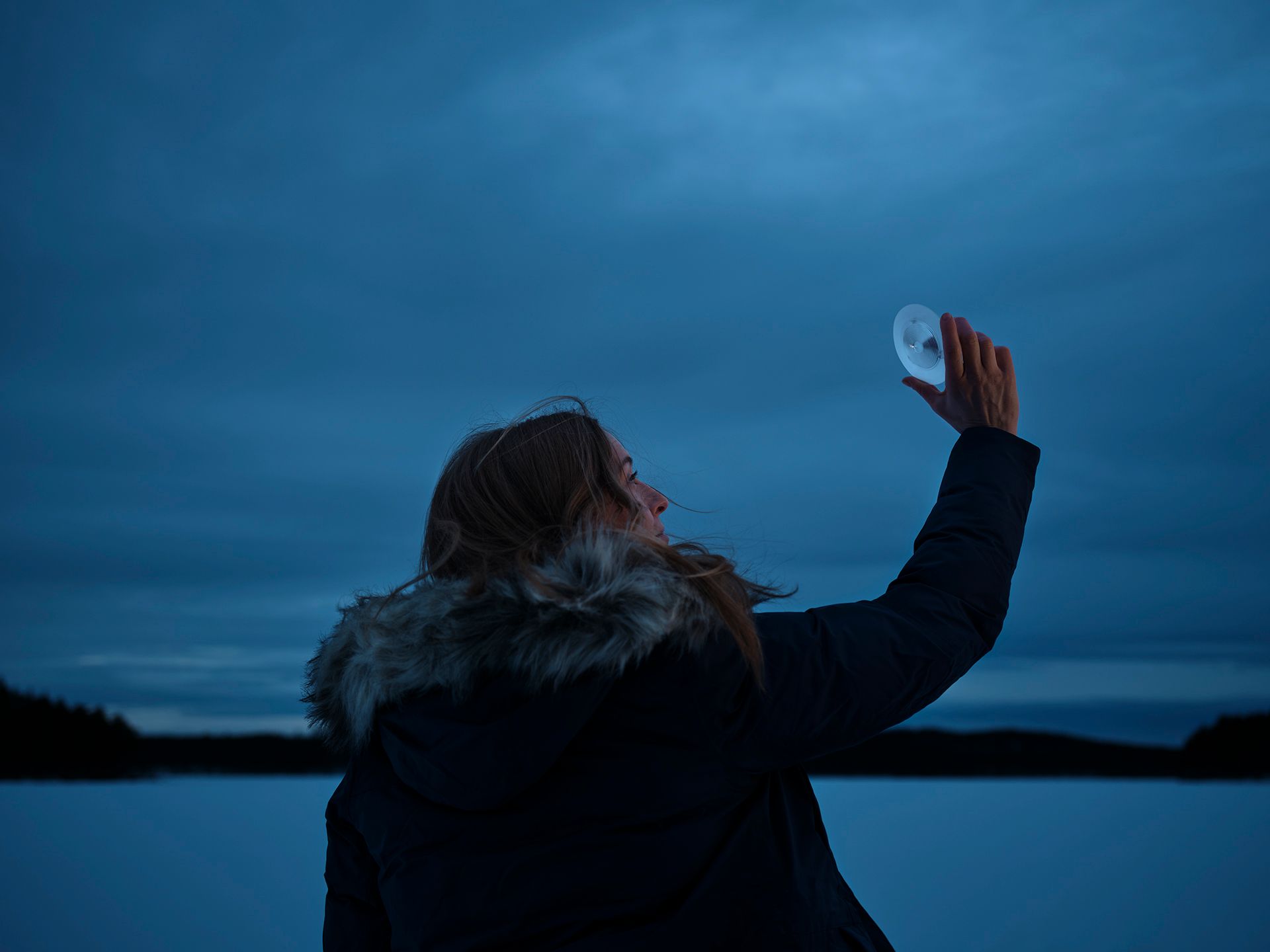 A woman is holding a piece of fresnel in her hand