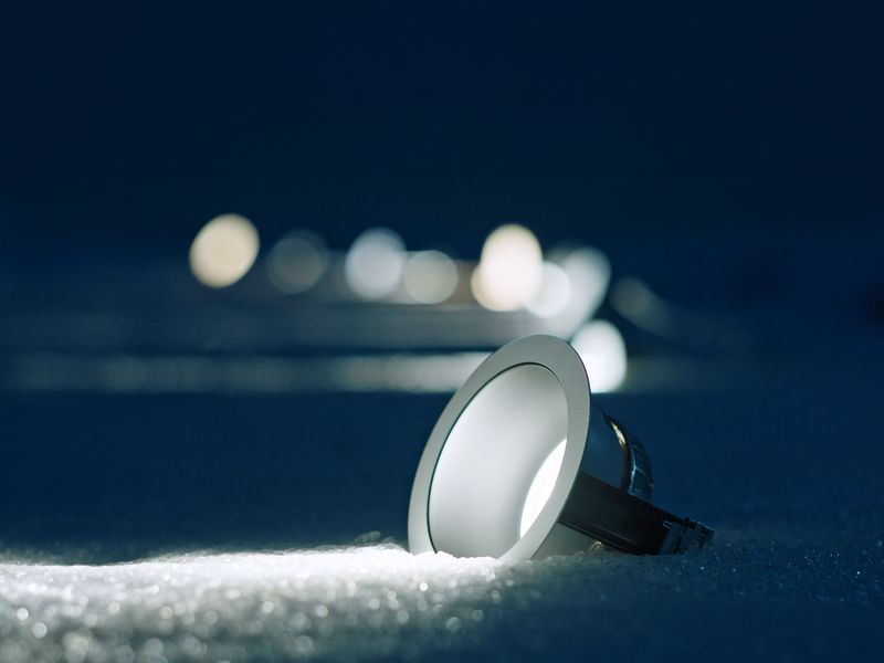 a ceiling light is sitting on top of a pile of snow .