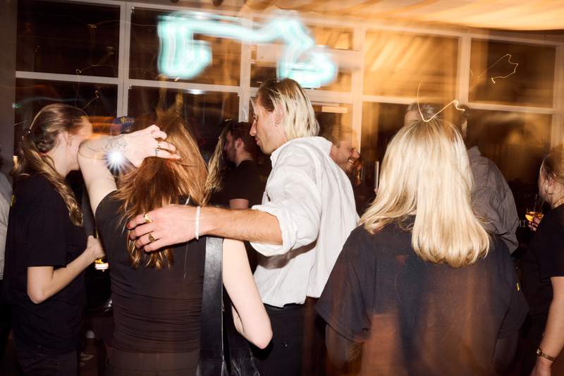 a group of people are dancing in a room at a party .