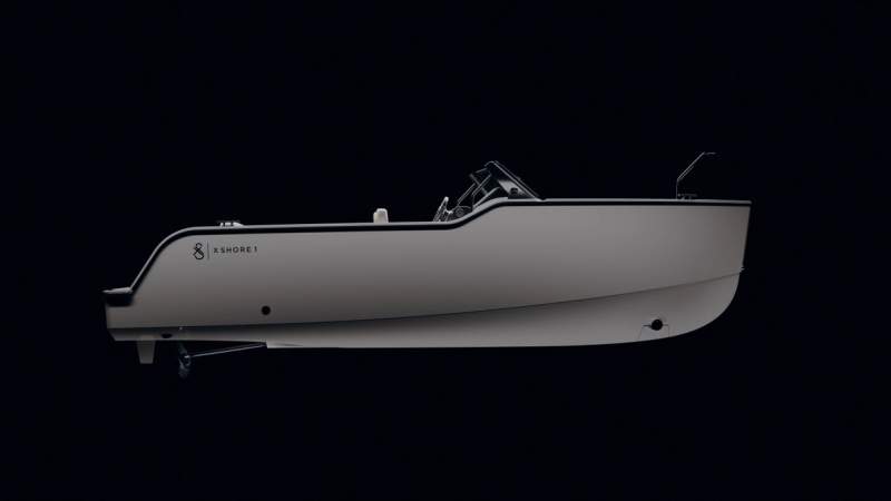 a white boat is sitting on a black surface on a black background .