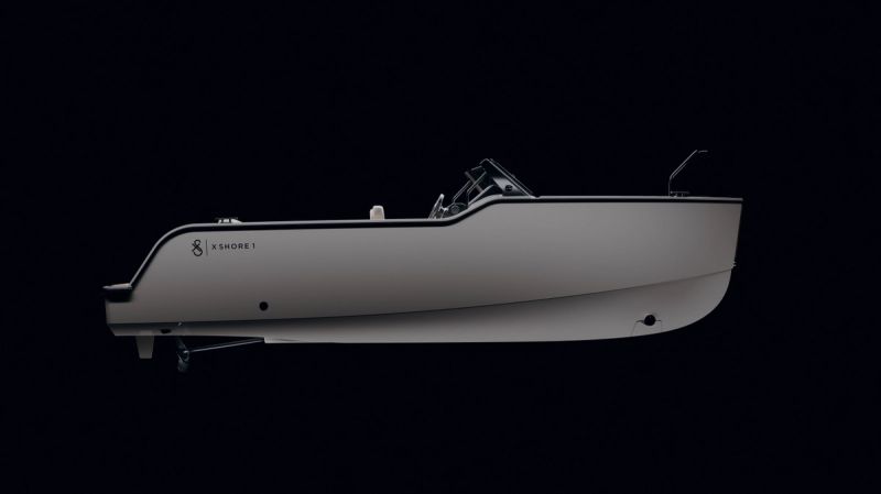 a white boat is sitting on a black surface on a black background .