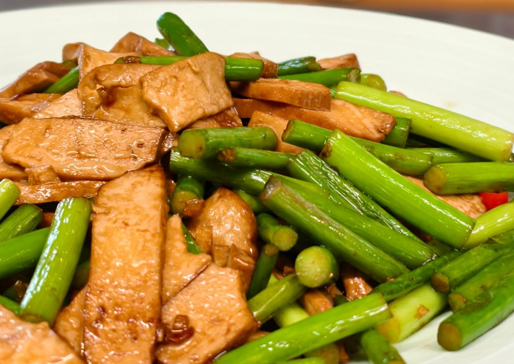 Stir-fried dougan with garlic shoots