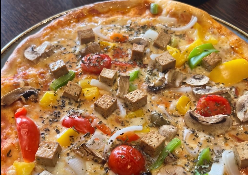Plant-based pizza topped with diced dougan