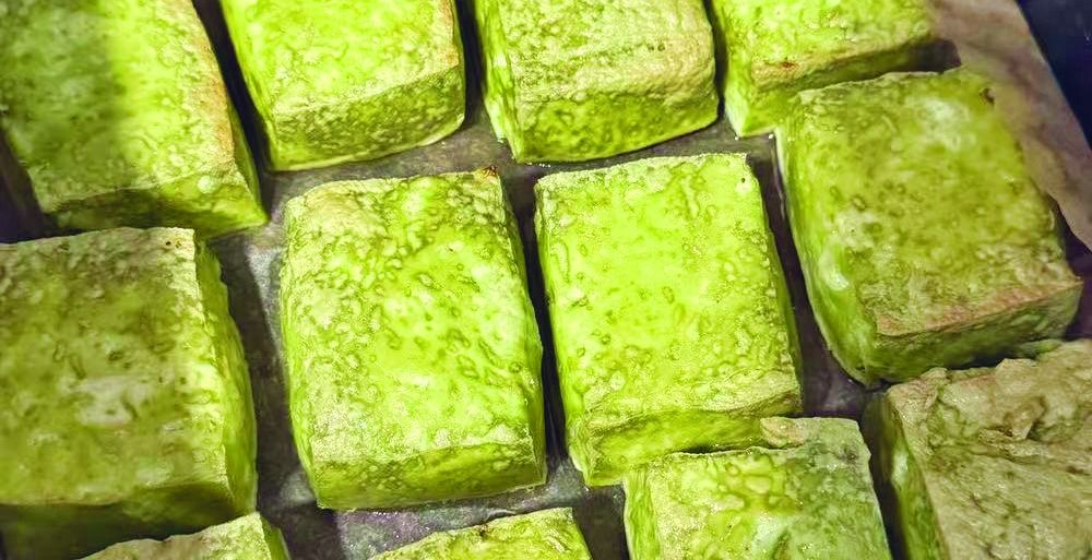 Fried firm tofu by Little Millstone shows a tint of green