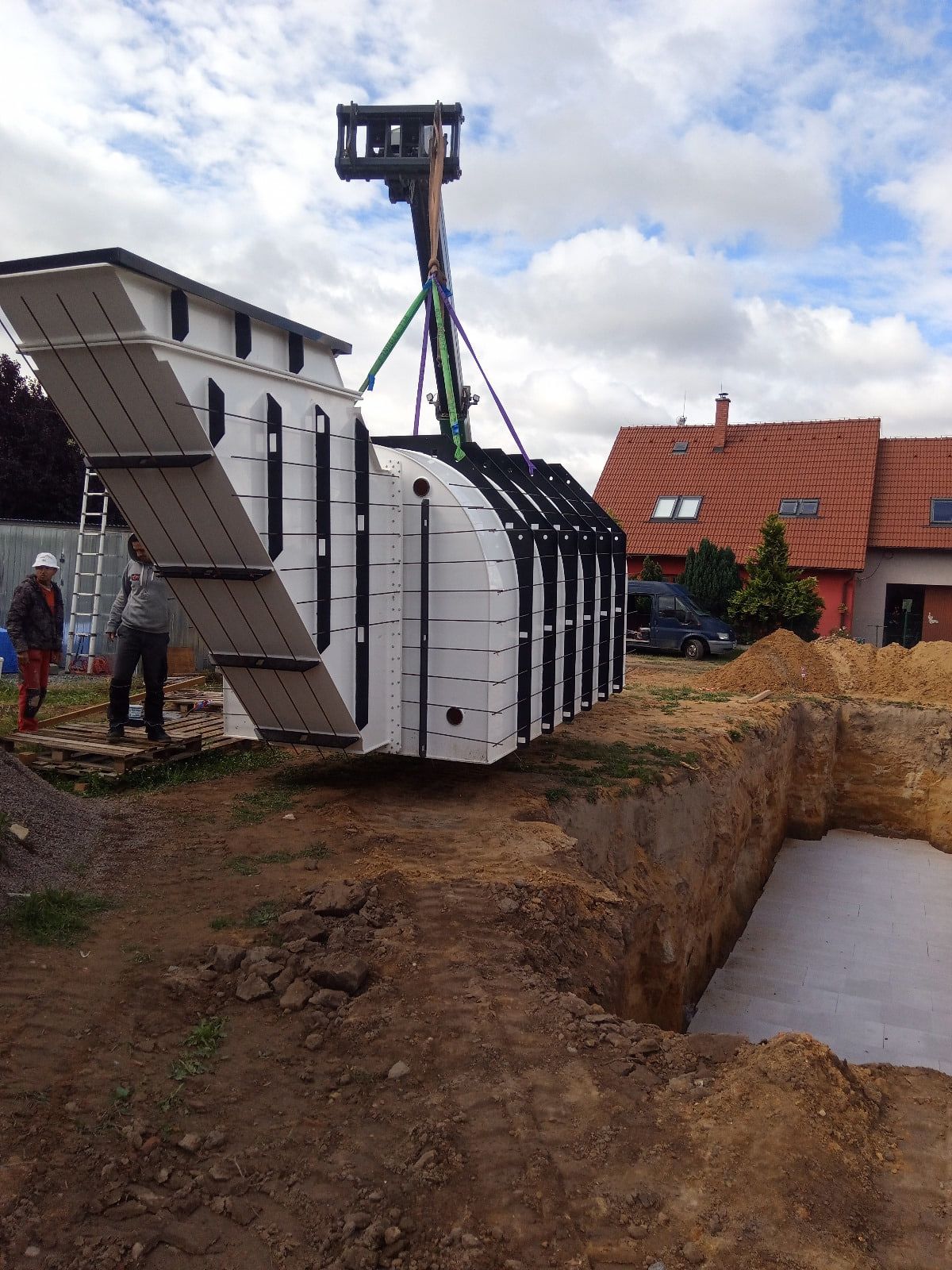 Vorgefertigter Schutzraum wird in die Baugrube eingehoben