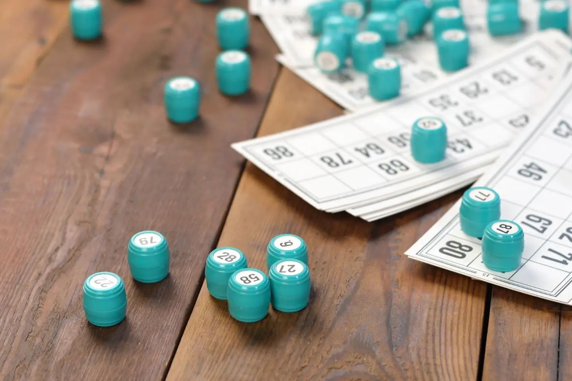 A collection of bingo cards and markers with numbers on them