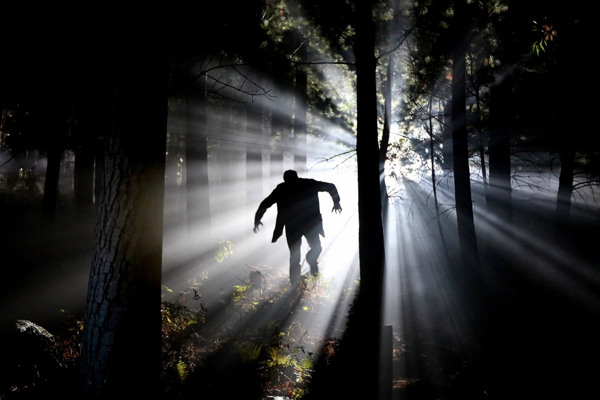 Frankenstein's Monster running through the woods