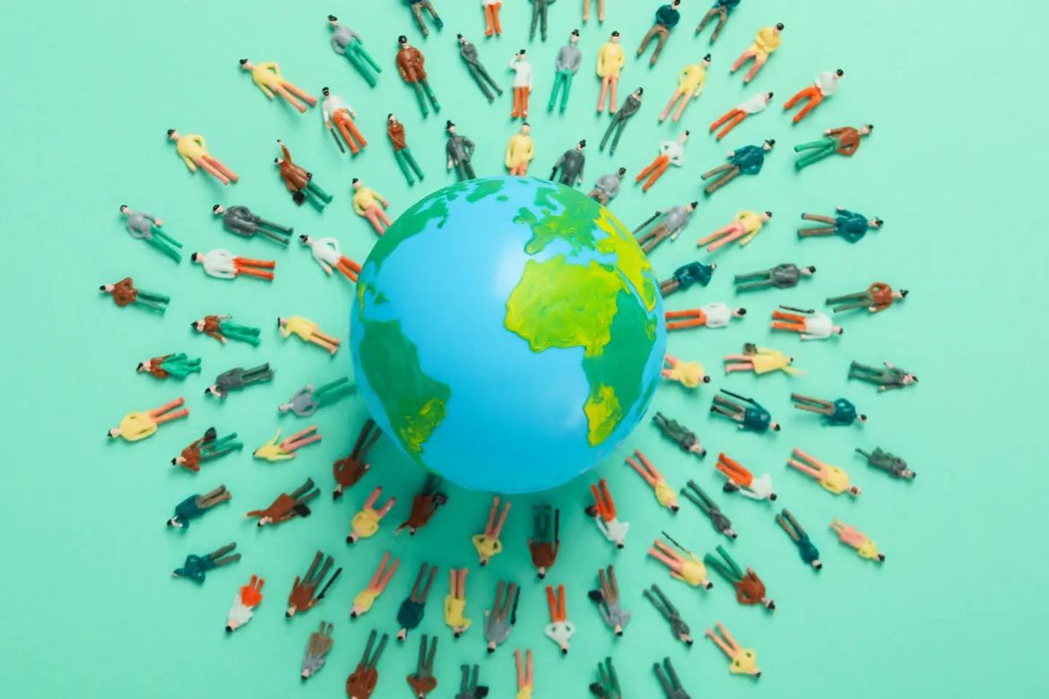 A globe on a green background with rows of people laying down around it