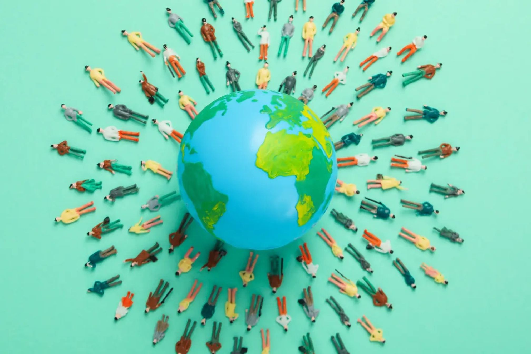 A globe on a green background with rows of people laying down around it
