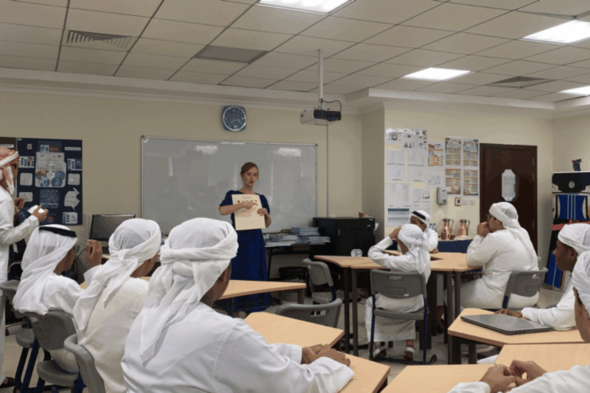Sarah Ledger teaching a group of male muslim teachers in Dubai