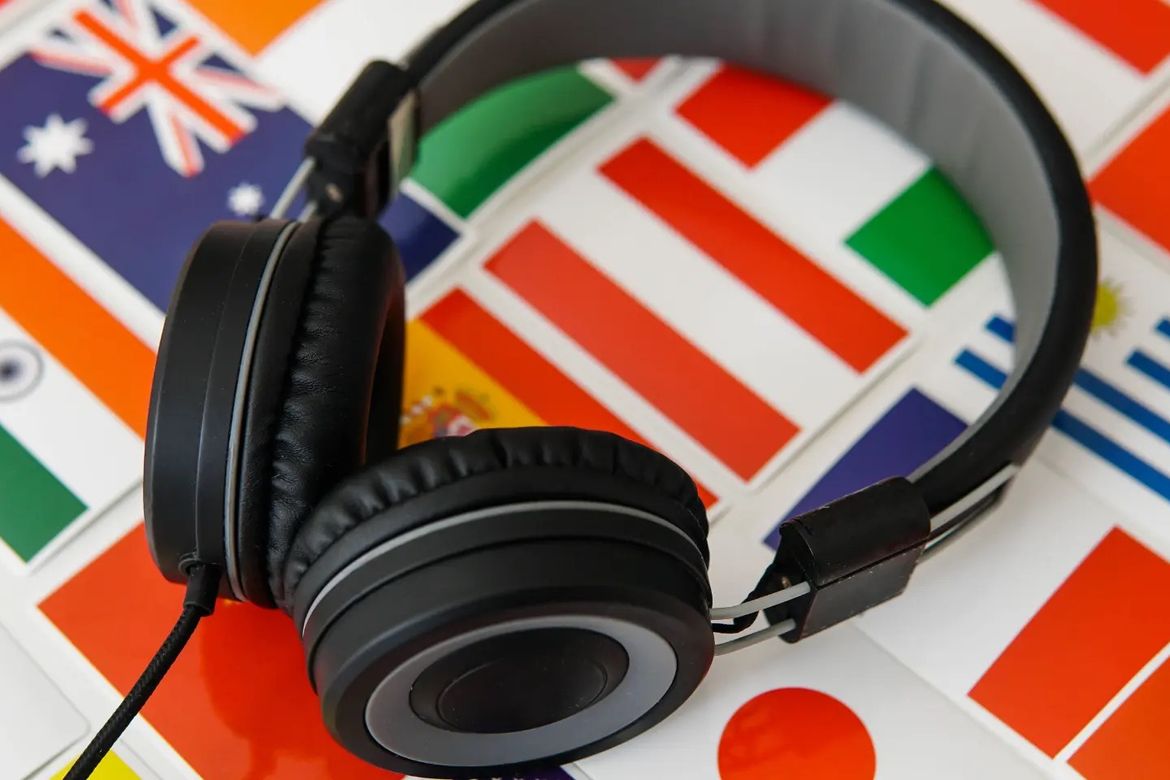 A headphone set on a background of world flags