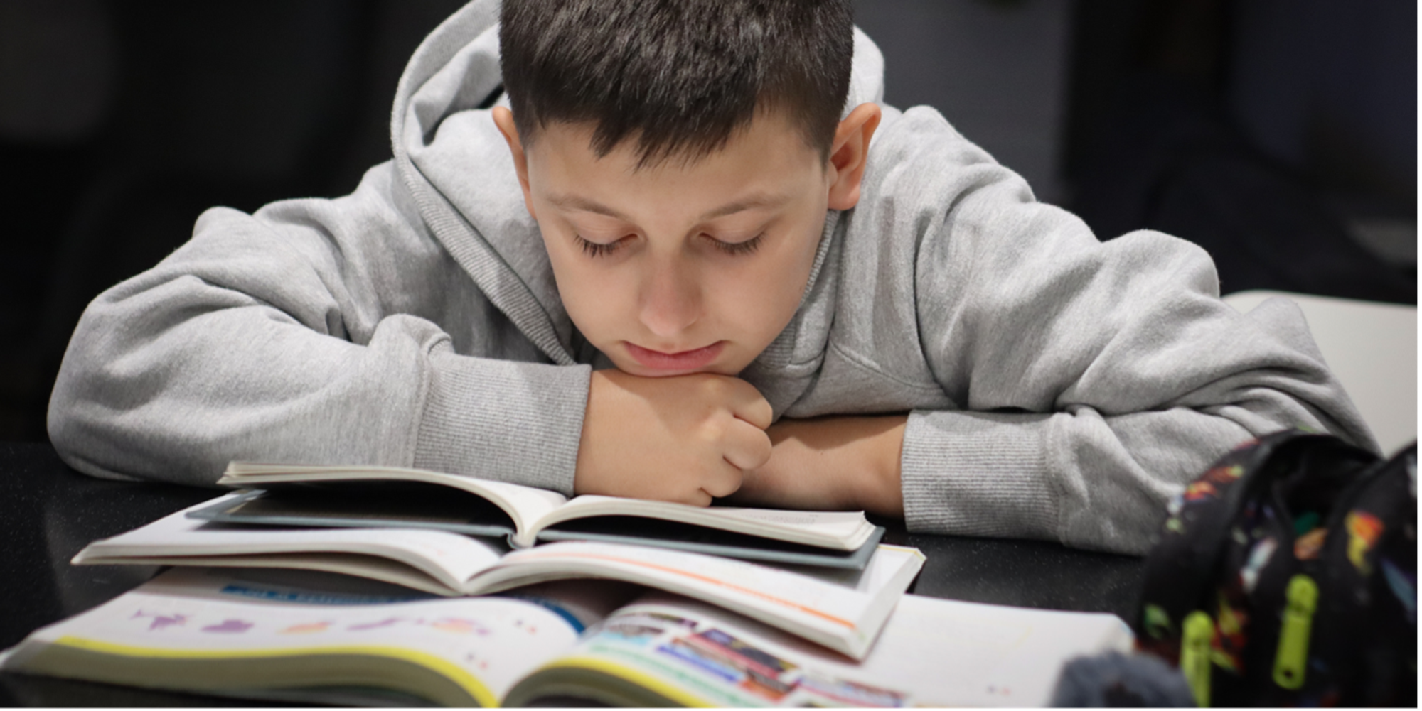 Boy reading books.